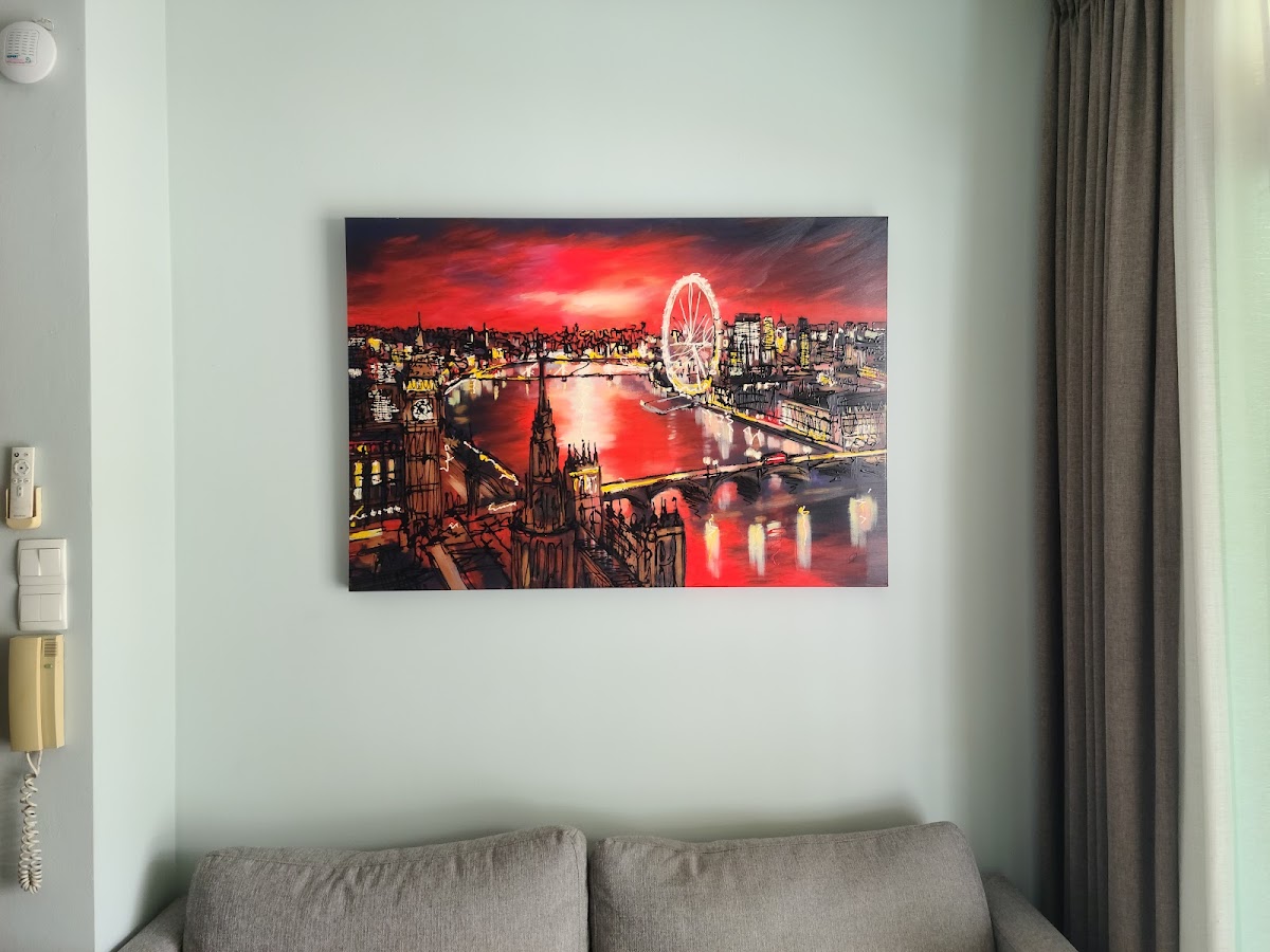 Large canvas painting hung above a sofa